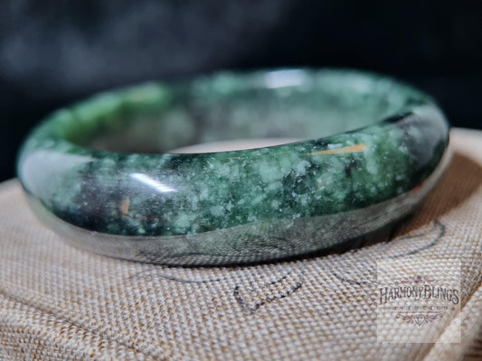 High-quality natural moss green jade bangle with white shimmer  a perfect feng shui gift for luck, Christmas, and New Year